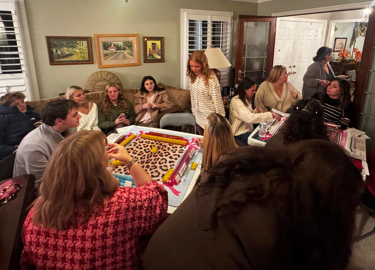 Family gathered around two mahjong tables during Thanksgiving