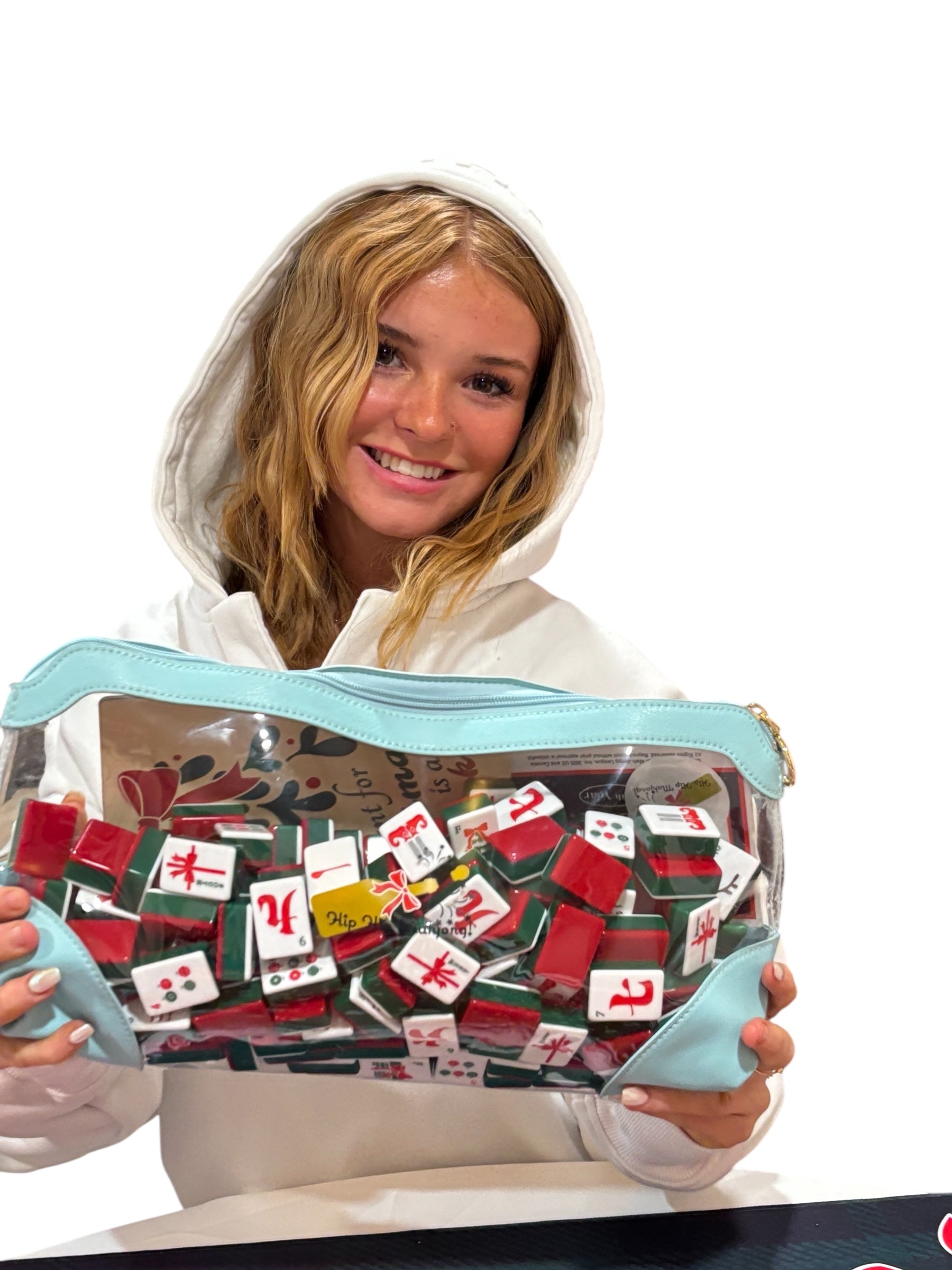 Person holding a transparent pouch filled with colorful items, possibly board game pieces, on a white background.