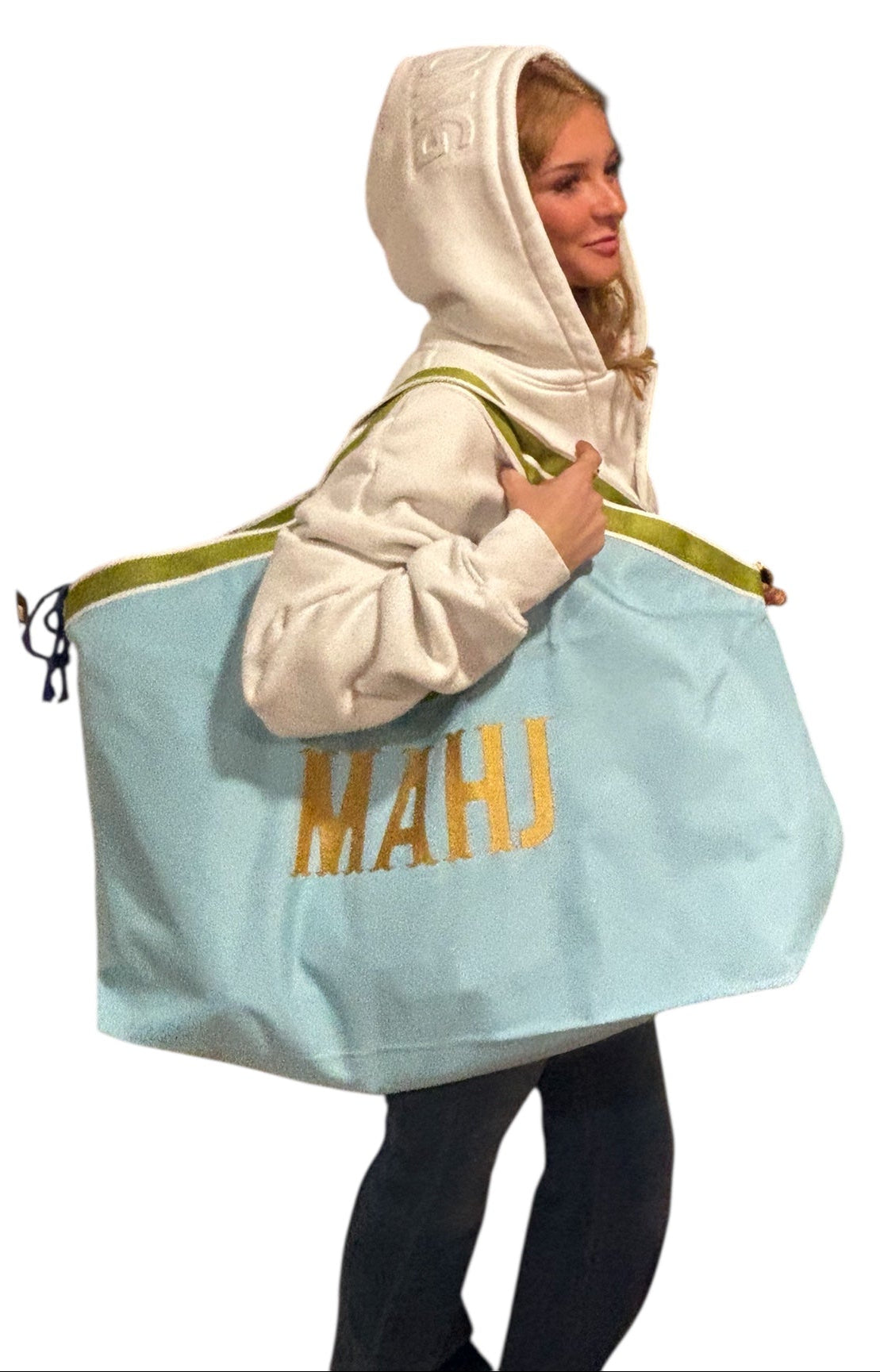 Person holding a large light blue bag with 'MAHU' branding on a white background